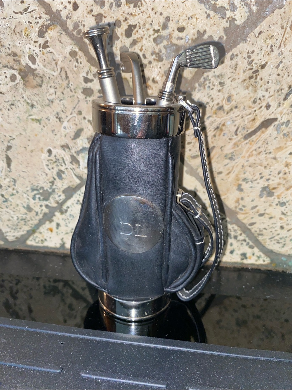 Black Mini Golf Bag Desk Accessory with 2 Chrome Clubs and one chrome tee.